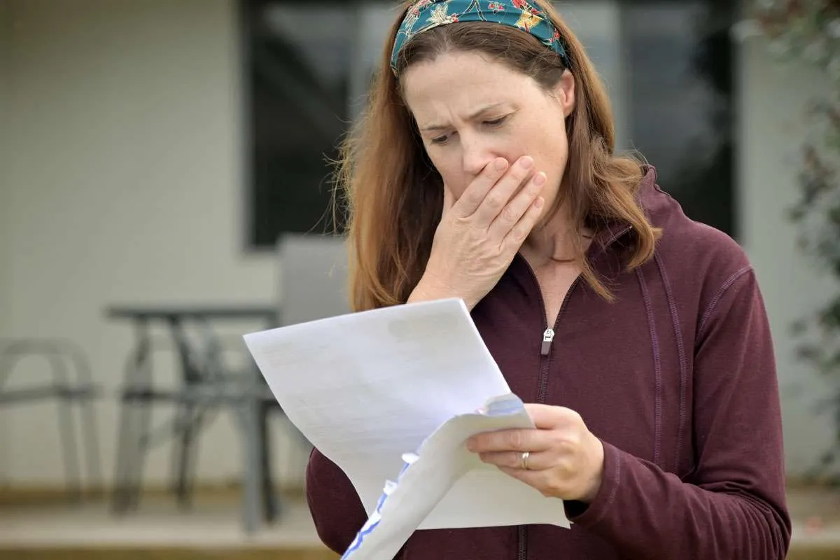 Homeowner reviewing a detailed roofing estimate document