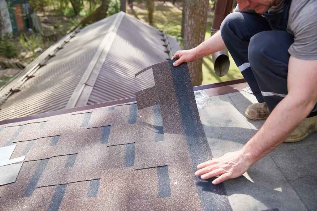 Close-up of architectural asphalt shingles being installed